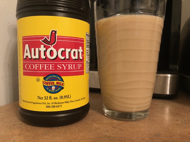 autocrat coffee syrup and glass of coffee milk